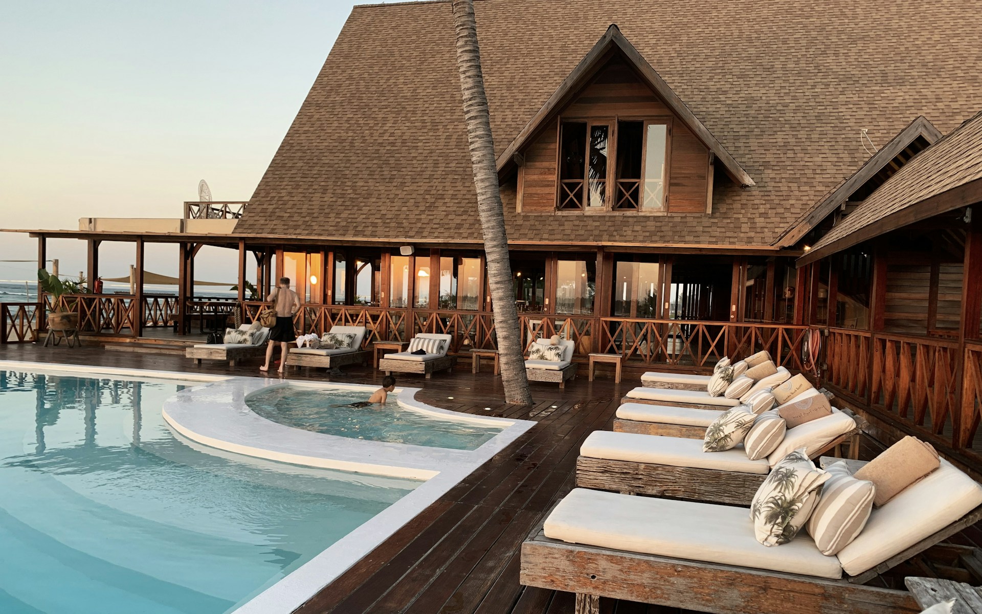 Twilight over a Mediterranean resort pool terrace set for a wedding celebration
